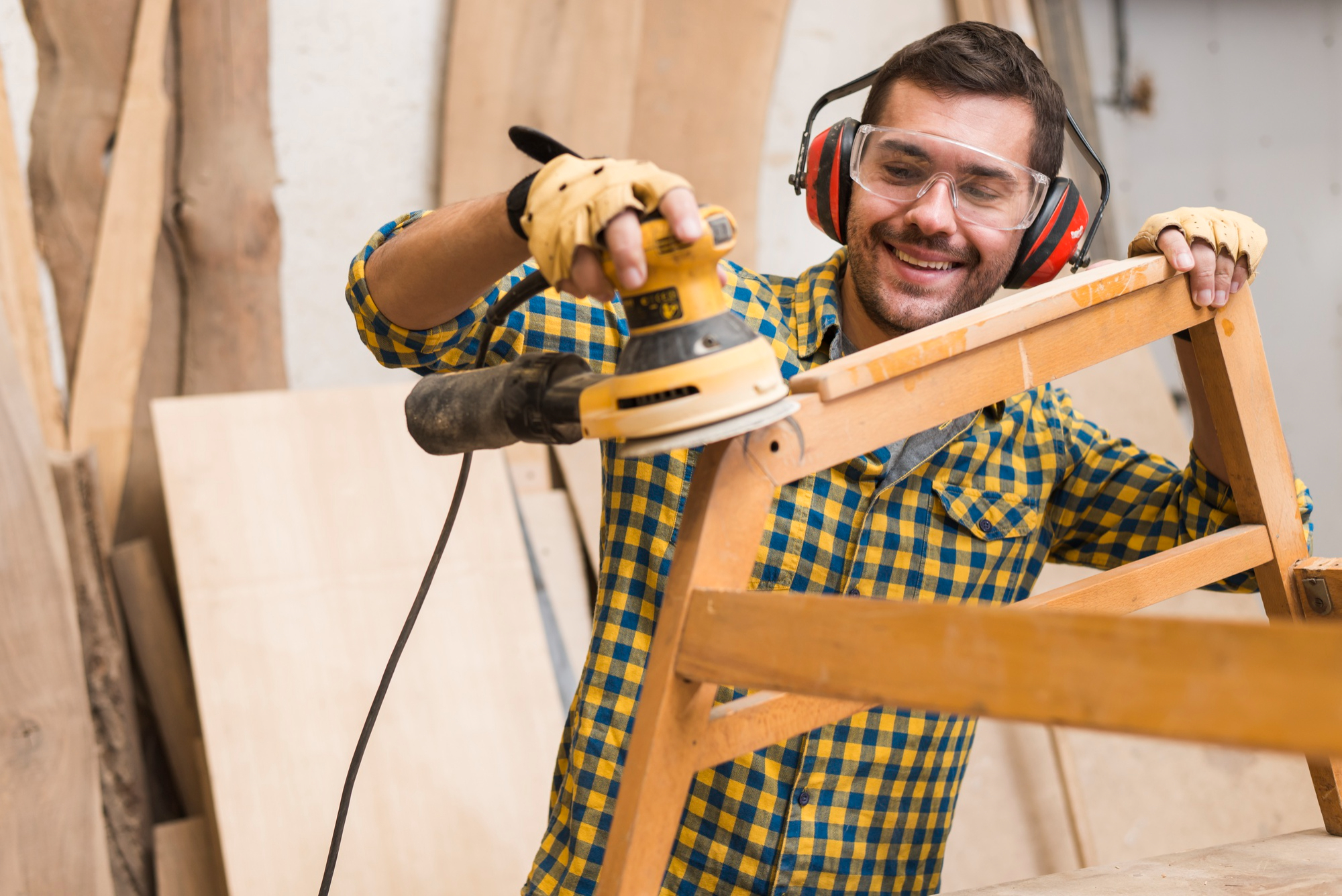 skilled-carpenter-is-using-power-sander-as-tool-polish-his-furniture